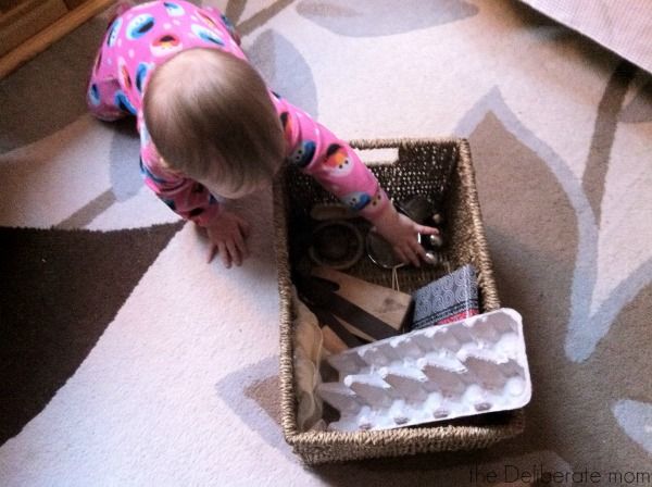 Infant playing with a treasure basket: Heuristic play http://thedeliberatemom.com