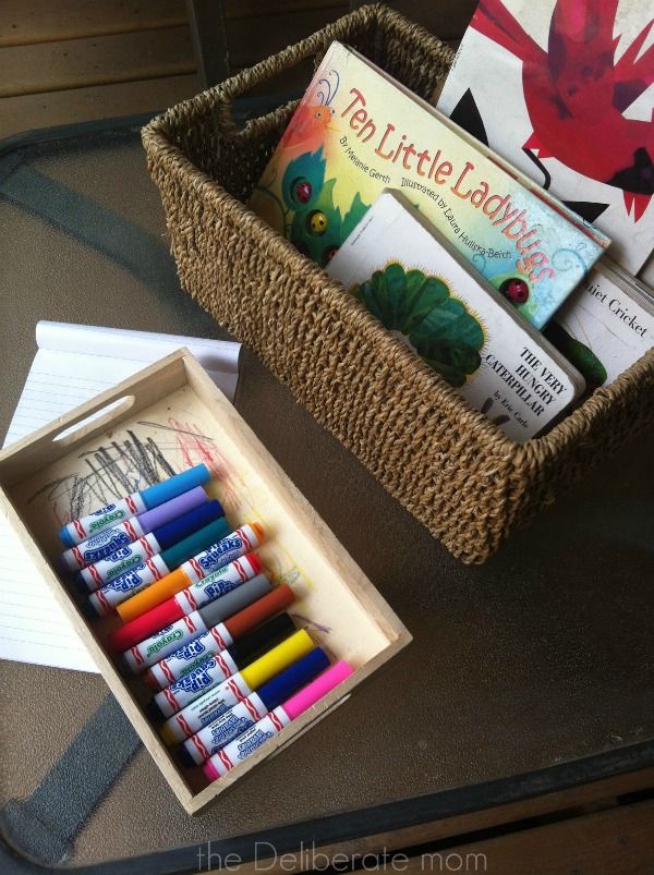 Play spaces for small backyards - books and art supplies readily available. http://thedeliberatemom.com